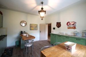 a kitchen with green cabinets and a table at Carlo Alberto B&B in Gavi