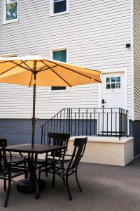 a table and chairs with an umbrella on a patio at Joynest Place in Newark