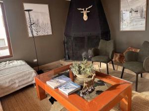 a living room with a table and a fireplace at Para 6 pax La Parva in Lo Barnechea +16 photos
