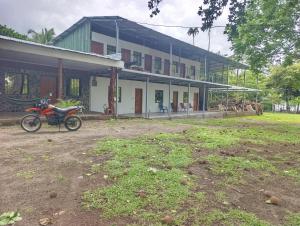 a motorcycle parked in front of a house at Kencho's Beach House-Sunset & Beachside stay in Ometepe in El Perú