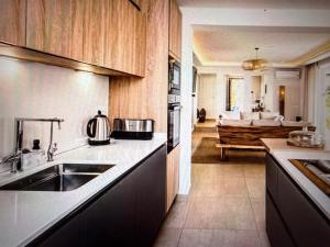 a kitchen with a sink and a kitchen with a living room at Luxury Villa Private Pool in Mahajanga