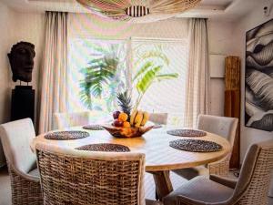 a dining room table with a bowl of fruit on it at Luxury Villa Private Pool in Mahajanga