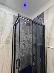 a shower in a room with a stone wall at Tropea Olympus Apartments in Santa Domenica +17 photos