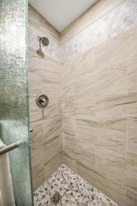 a bathroom with a shower with a glass door at Basecamp 2 at the Cedaredge Lodge in Cedaredge