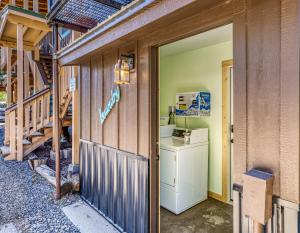 a laundry room with a washer and dryer next to a house at Basecamp 2 at the Cedaredge Lodge in Cedaredge