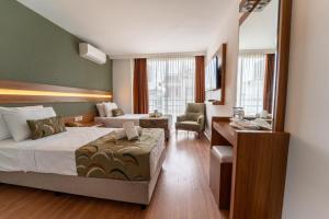 a hotel room with two beds and a desk at La Brisa Hotel in Antalya +94 photos