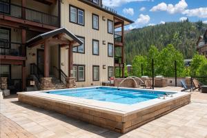 a swimming pool in front of a building at Fraser Crossing 3417 in Winter Park +11 photos