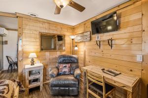 a room with a desk and a chair and a television at Basecamp 2 at the Cedaredge Lodge in Cedaredge