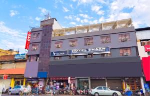 a building with a hotel shark sign on it at Hotel Shaan- M I Road City Centre in Jaipur