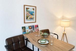 a dining room table with two chairs and wine glasses at NOBLE APART Saarbrücken City Center in Saarbrücken