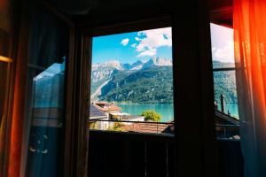 a window with a view of a lake and mountains at Cozy Apartment - Stunning Views in Brienz