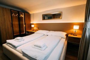a bedroom with a large bed with white towels on it at Cozy Apartment - Stunning Views in Brienz