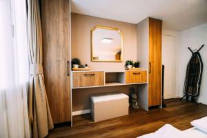 a bathroom with a vanity with a mirror and a toilet at Cozy Apartment - Stunning Views in Brienz