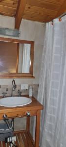 a bathroom with a sink and a shower curtain at Matices Patagonicos in San Carlos de Bariloche +38 photos