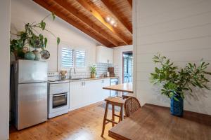 a kitchen with white cabinets and a wooden table at The Heights in St Helens