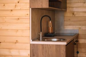 a sink in a kitchen with a wooden wall at BetosGarden in Ulcinj +83 photos