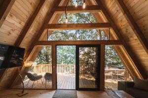 a large glass door in a cabin with a deck at BetosGarden in Ulcinj