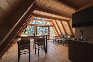 a kitchen and living room in a log cabin at BetosGarden in Ulcinj