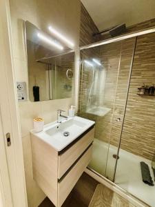 a bathroom with a sink and a shower at La Casita cerca de la playa in Santander