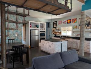 a kitchen and living room with a couch and a table at Denver Oasis 5BR Home with Hot Tub, Sleeps 16 in Denver