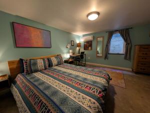 a bedroom with a bed and a desk in a room at Denver Oasis 5BR Home with Hot Tub, Sleeps 16 in Denver