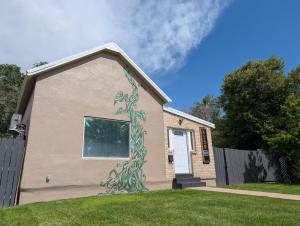 a house with a painting on the side of it at Denver Oasis 5BR Home with Hot Tub, Sleeps 16 in Denver