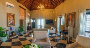 a living room filled with furniture and a chandelier at Hotel Capellán de Getsemaní in Cartagena de Indias