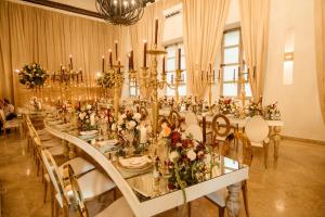 a dining room with a long table with flowers and candles at Hotel Capellán de Getsemaní in Cartagena de Indias +106 photos