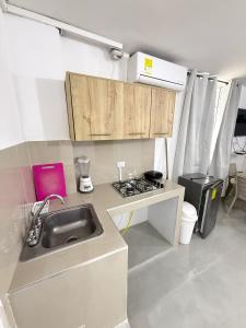 a small kitchen with a sink and a stove at Caribe 102-1 in San Andrés