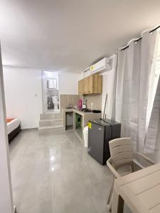a small kitchen with a refrigerator and a table at Caribe 102-1 in San Andrés +7 photos