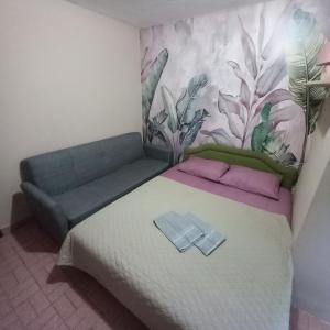 a bedroom with a bed and a couch in it at Sky 2 Petrovac in Babalonija +5 photos