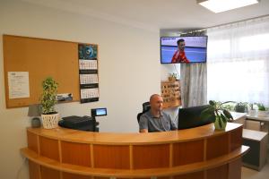 a man sitting at a desk in an office at Dom Sportowca in Krosno +20 photos