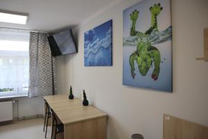 a dining room with a table and a painting on the wall at Dom Sportowca in Krosno