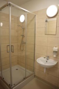 a bathroom with a shower and a sink at Dom Sportowca in Krosno