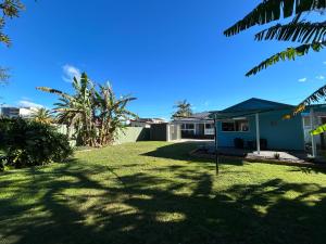 a yard with a house and some trees at Spacious Stylish Coastal Escape in Tuncurry