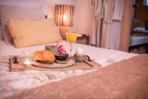 a breakfast tray with a plate of food on a bed at AuxiliumWellness Get Back to Serenity in Grobbendonk +46 photos