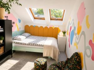 a bedroom with a bed with a yellow headboard at GóralSki in Wisła