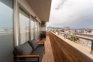 a balcony with a couch and a view of a city at La Brisa Hotel in Antalya
