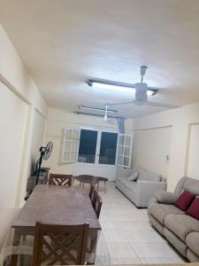 a living room with a couch and a table at Marselia Beach 3 in Dawwār Muḩammad Abū Shanab