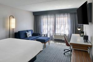 a hotel room with a bed and a desk at Courtyard Providence Downtown in Providence +35 photos