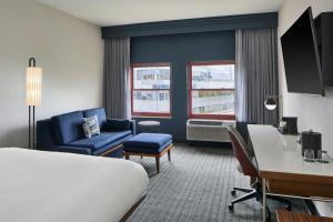 a hotel room with a bed and a desk and chair at Courtyard Providence Downtown in Providence