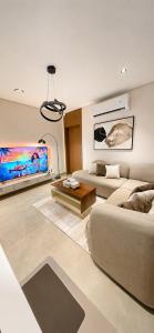 a living room with a couch and a table at سويت مسك غرفة وصالة بلمسة عصرية راقية in Dammam