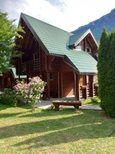 a log cabin with a bench in front of it at Rafting Centar Bato in Plužine