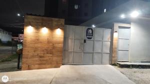 a building with a garage door with lights on it at Loft Essence in Volta Redonda