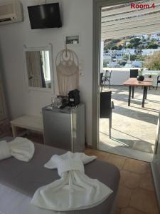 a room with a bed and a view of a patio at Sunset Hotel Kini Beachside in Kini +86 photos