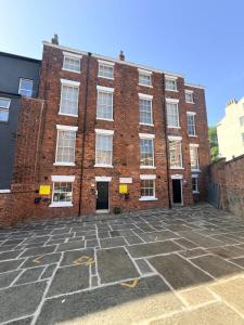 a red brick building with white windows on it at Fishergate Residences in Preston