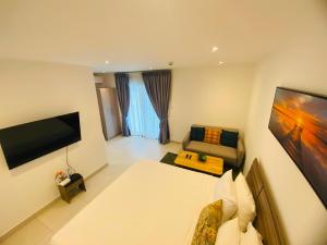 a hotel room with a bed and a couch at Executive Studio at Bantree in Accra