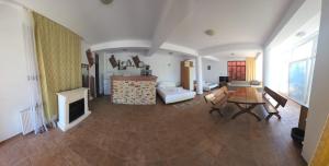 a large room with a living room with a fireplace at Vila Madi in Vama Veche +36 photos