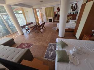 a living room with a couch and a table and chairs at Vila Madi in Vama Veche