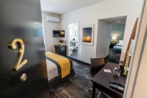 a hotel room with a bed and a mirror at Steveston Cafe & Hotel in Richmond +38 photos